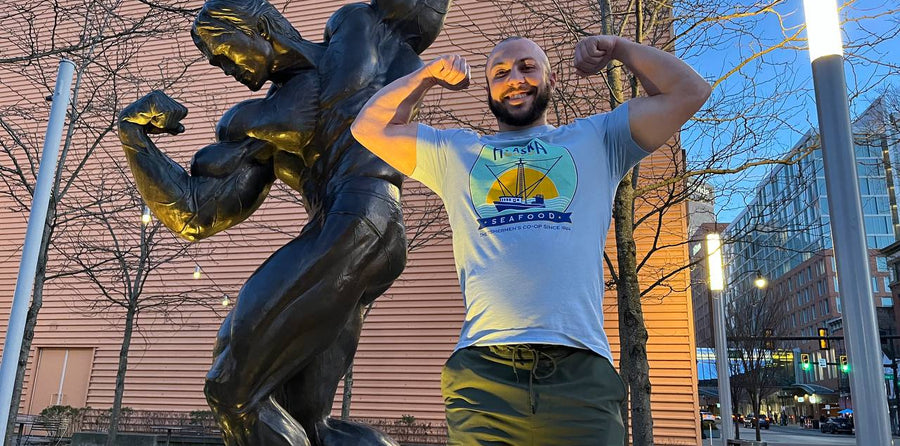 Athlete posing with Arnold statue