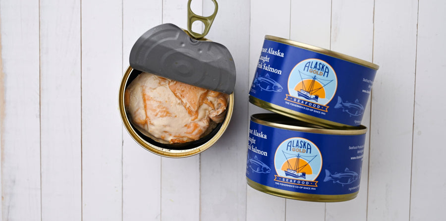Canned Salmon. 3 cans, one is open and 2 cans show the Alaska Gold Seafood label.