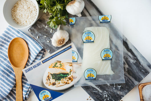 Frozen seafood in vacuum-sealed pack with herbs and on a table with spoons