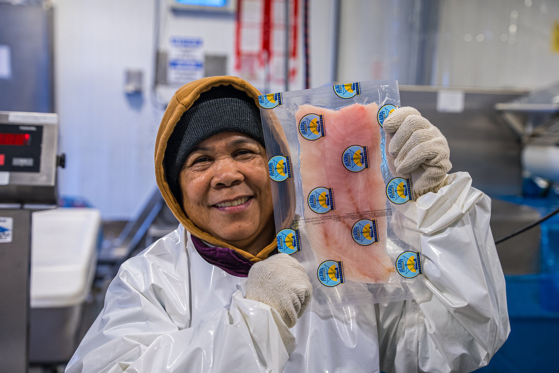 A worker showing a rockfish fillet