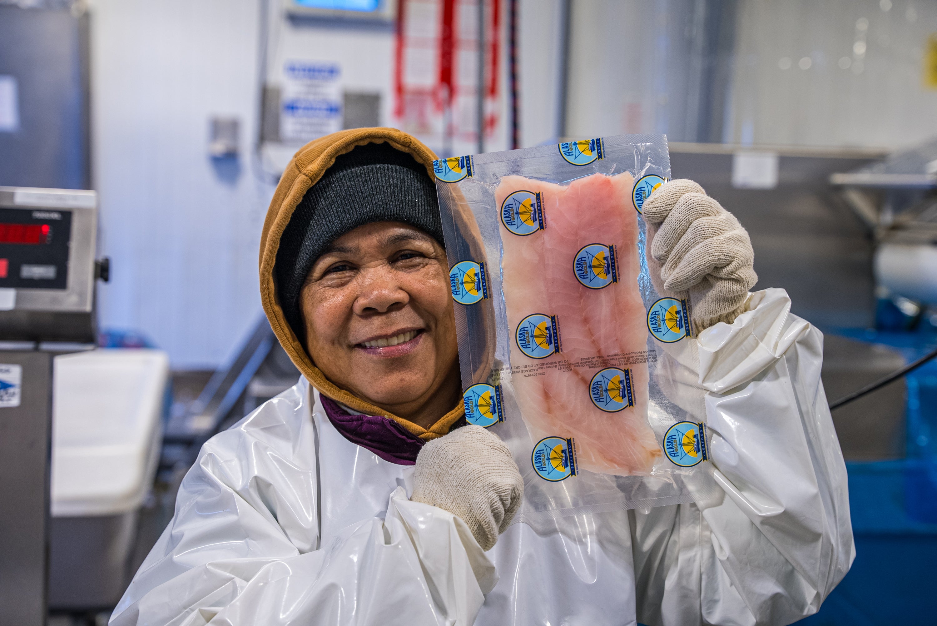 A worker showing a rockfish fillet