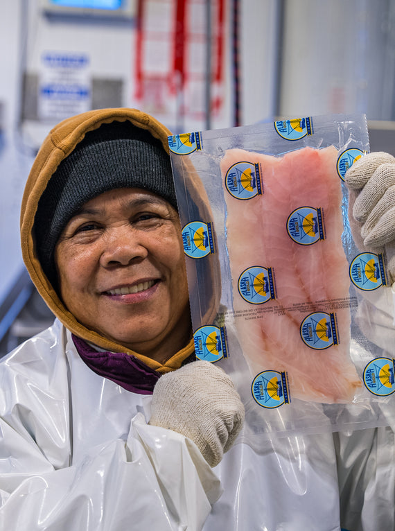 A worker showing a rockfish fillet