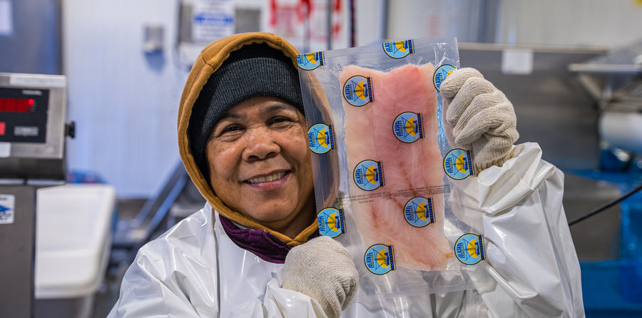 A worker showing a rockfish fillet