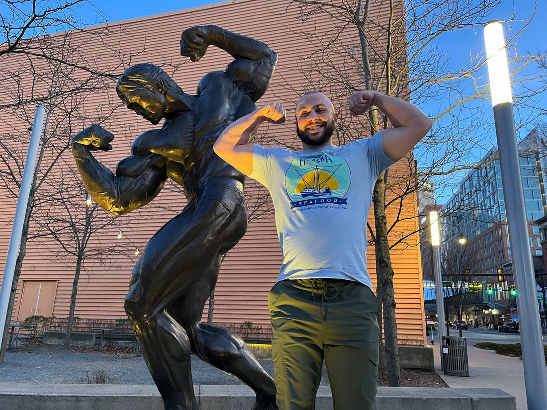 Athlete posing with Arnold statue