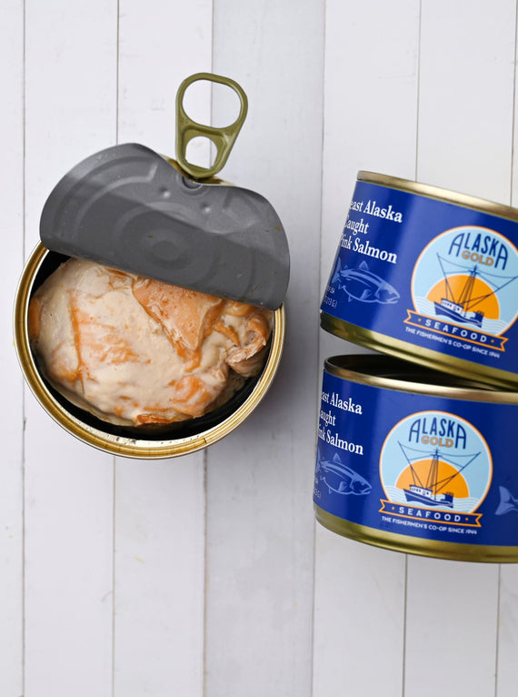 Canned Salmon. 3 cans, one is open and 2 cans show the Alaska Gold Seafood label.