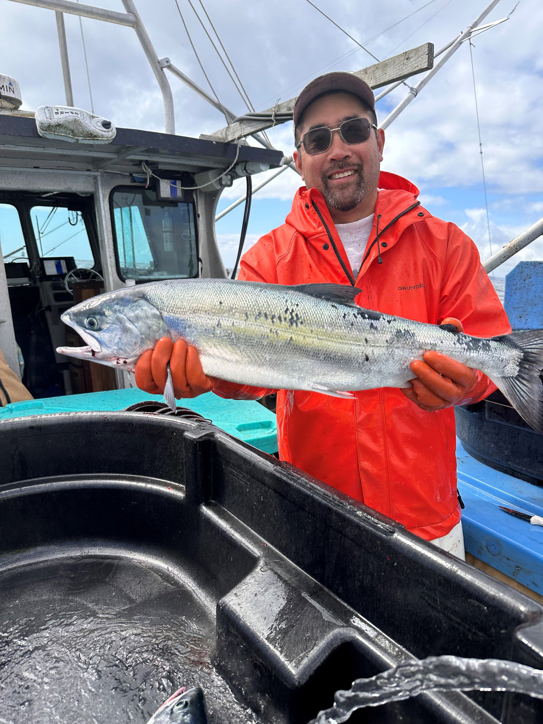 Fisherman holding a wild salmon