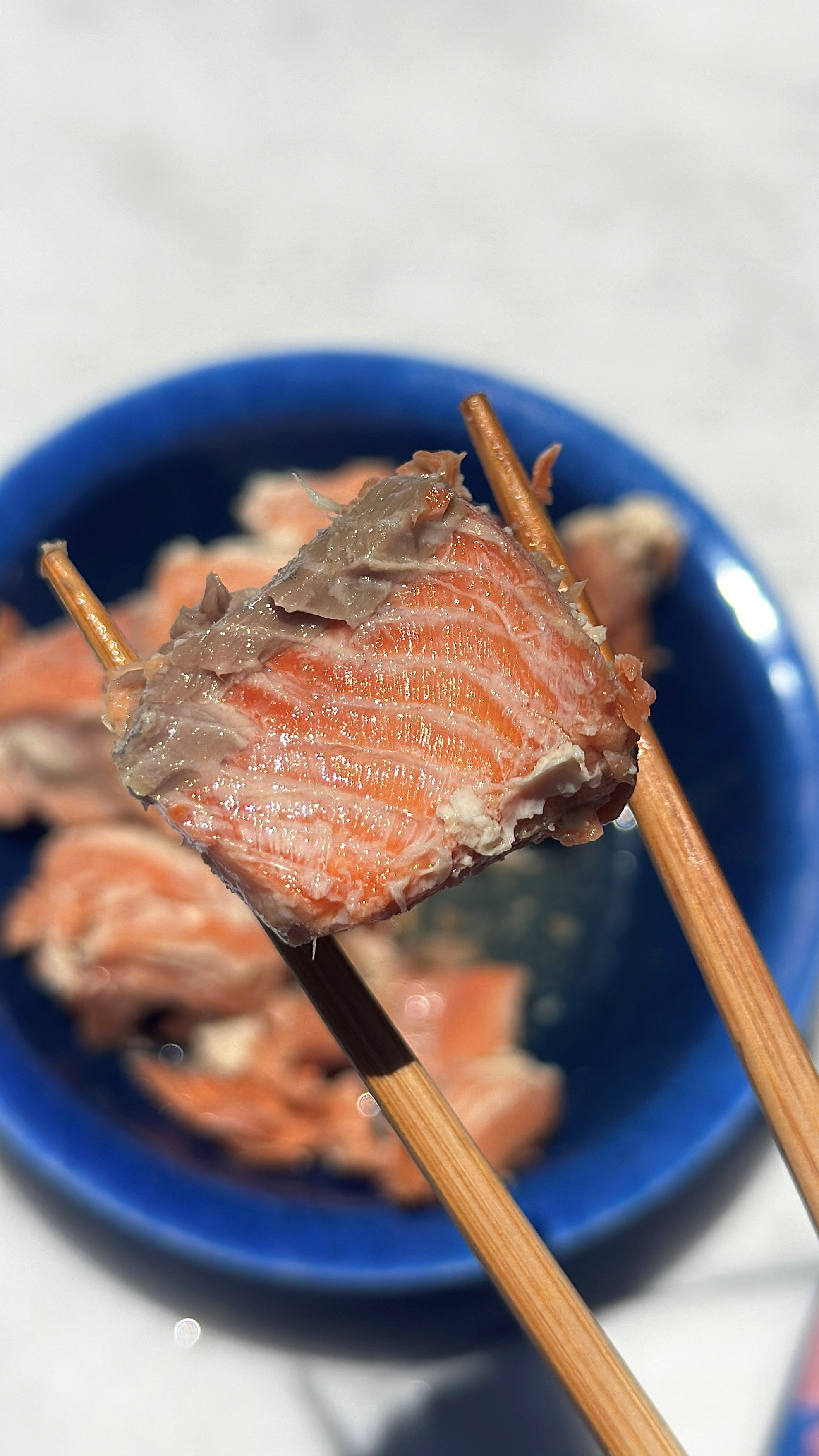 canned coho salmon close-up with chop sticks